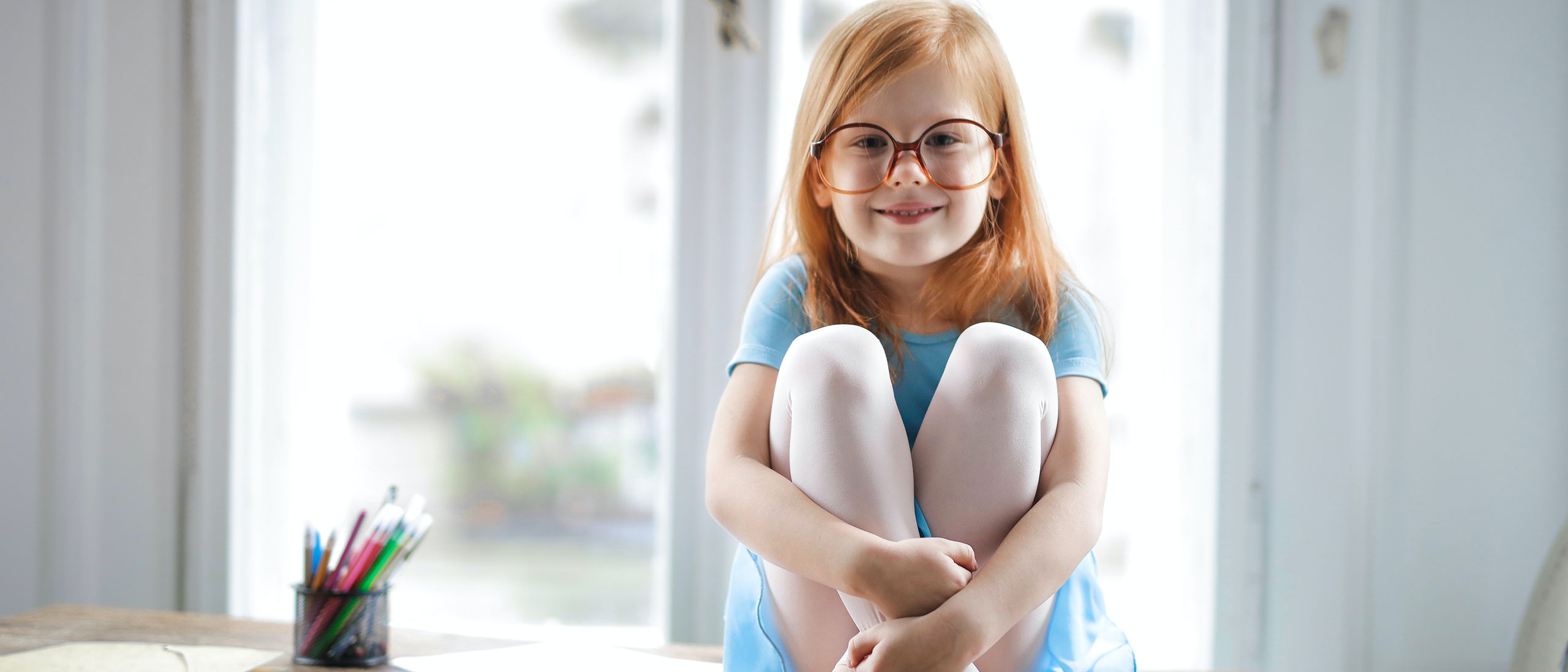 Girl with glasses sitting